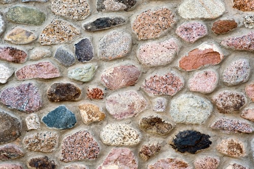 Preview: Flat detail view of a wall made from different stones. Abstract stone background.