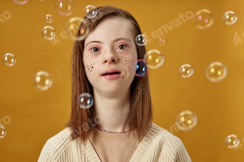 Preview: Portrait of Smiling Girl with Hair Blowing Among Bubbles