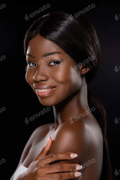 Preview: portrait of african american woman looking at camera isolated on black