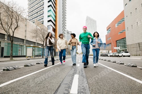 Preview: Group of diverse young friends running together on street