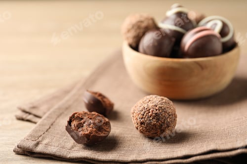 Preview: Different delicious chocolate truffles on wooden table