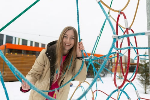 Preview: Woman Standing in Front of Rope Structure