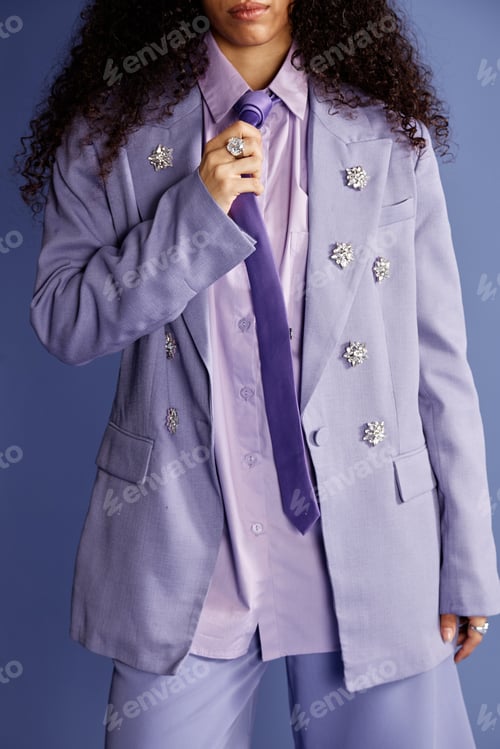Preview: Young Woman Adjusting Tie during Fashion Photoshoot