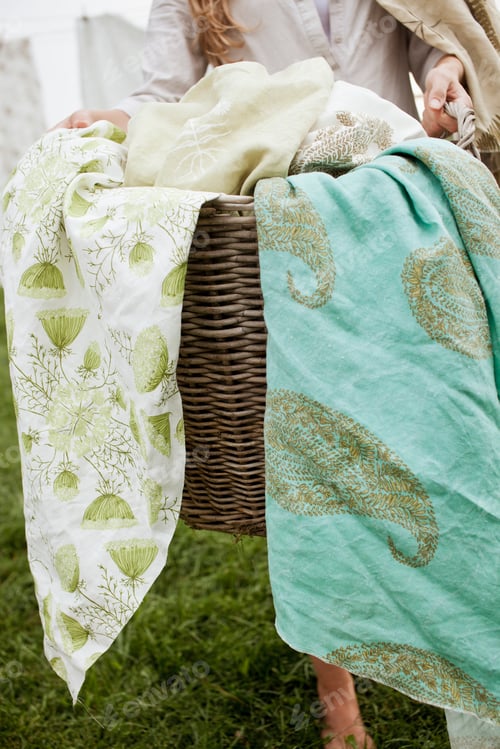 Preview: A basket overflowing with household linens. Washing basket.
