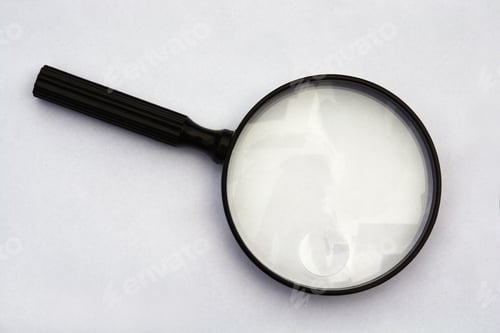 Preview: High angle top view isolated closeup shot of a magnifying glass on a white background