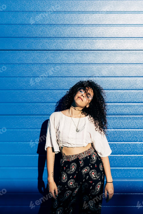 Preview: Woman posing against roller shutters