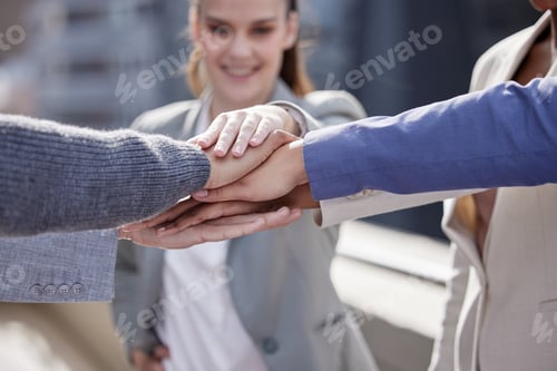 Preview: Shot of a group of unrecognizable businesspeople stacking their hands together outside