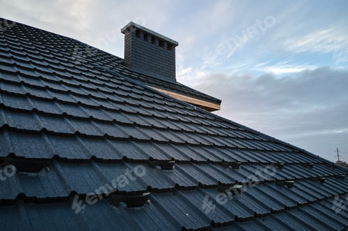 Preview: Snow guard for safety in winter on house roof top covered with ceramic shingles. Tiled covering of