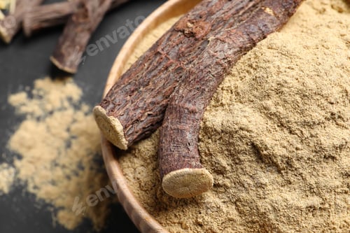 Preview: Powder and dried sticks of liquorice root in bowl, closeup