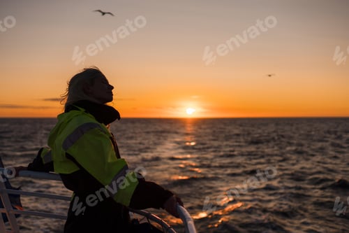 Preview: Young female tourist in Iceland enjoying view of landscapes and travel destinations. Whale watching
