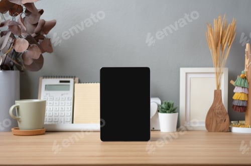 Preview: Blank screen tablet on working desk decor with stationery at home