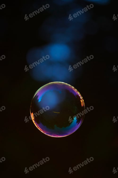 Preview: Closeup shot of a floating soap bubble with dark blue background