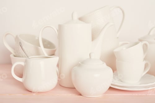 Preview: Set of white dishes on table on light background