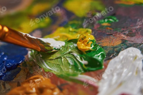 Preview: Close up of brush mixing acrylic paints