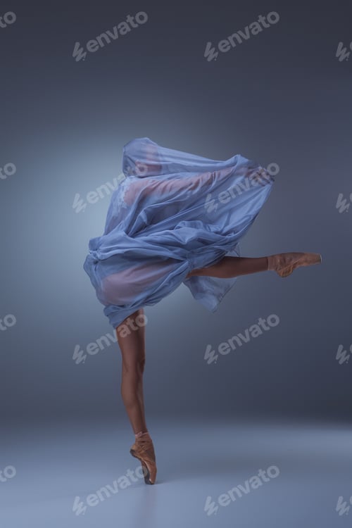 Preview: The Beautiful Ballerina Dancing In Long Blue Dress On Blue Background