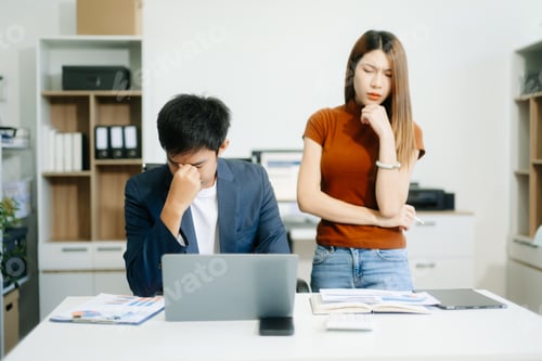 Preview: Furious two Asian businesspeople arguing strongly after making a mistake at work