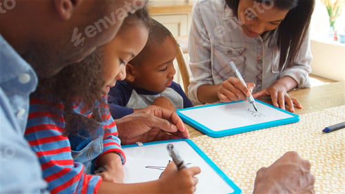 Preview: Parents And Children Drawing On Whiteboards Sitting Around Table At Table