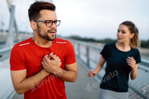 Preview: Man feeling pain in heart during exercise outdoor