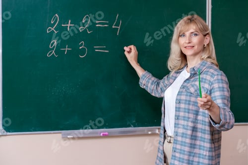 Preview: Back to school. The professor solves the problem at the blackboard