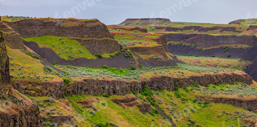 Preview: Scenic Landscape of Washington Canyons with Lush Greenery and Rugged Cliffs Under a Cloudy Sky