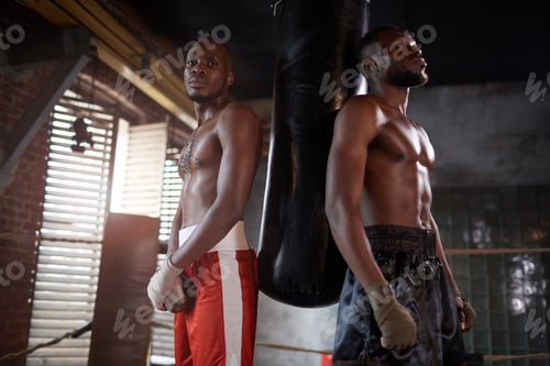 Preview: Two boxers training with punching bag