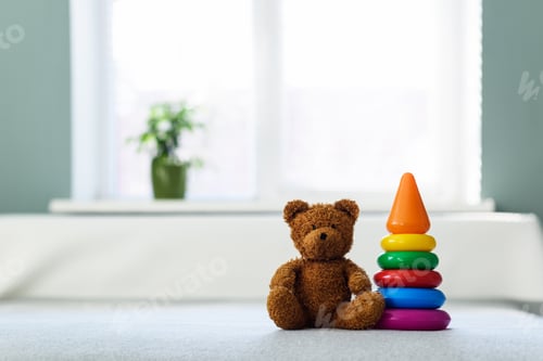 Preview: Plush teddy bear toy on white bed