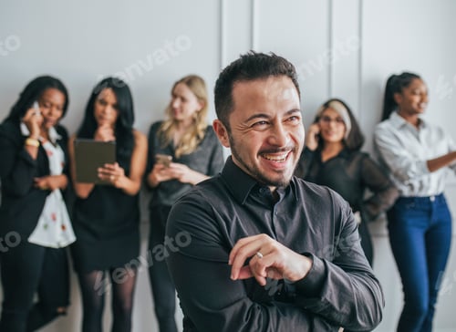 Preview: CEO with his employees standing by a white wall