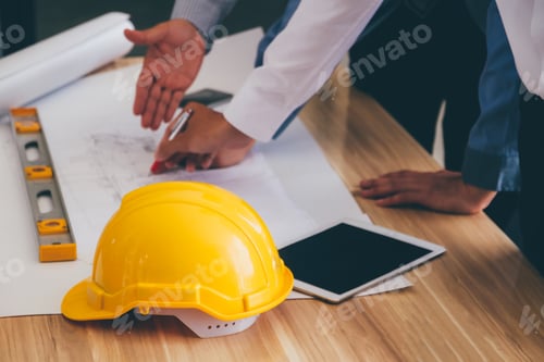 Preview: Team of engineers discussing architecture plan sketch at the construction site. Selective focus