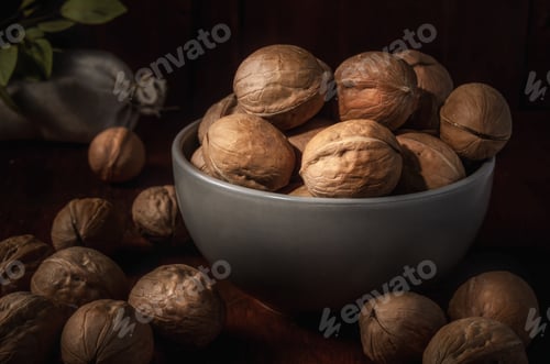 Preview: Bowl of Walnuts on Dark Wood Table