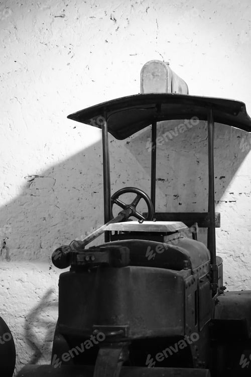 Preview: Vertical black and white shot of an old road roller