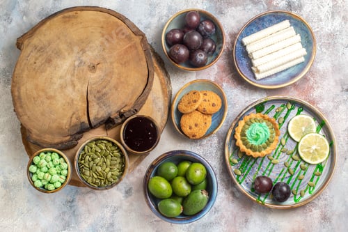 Preview: top view little cake with fruits and candies on the light background dessert sweet biscuit