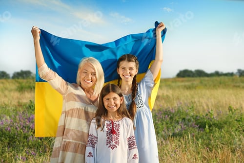 Preview: Happy family with national flag of Ukraine in field