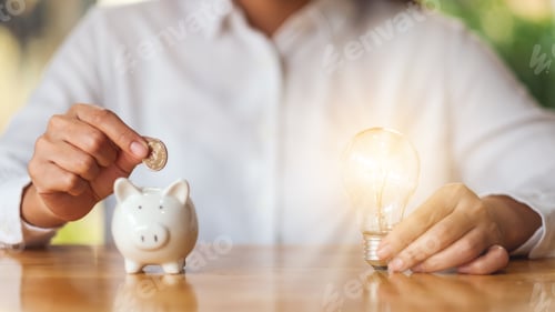 Preview: A woman putting coins into a piggy bank while holding a light bulb for saving money concept
