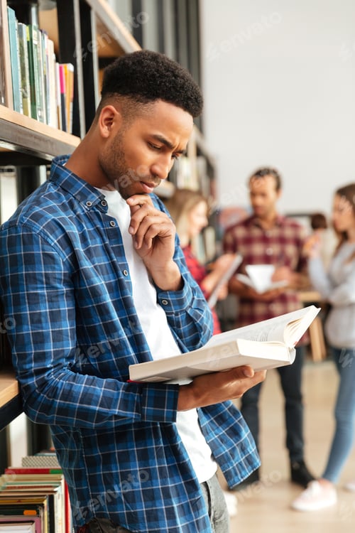 Preview: Concentrated serious african man reading book