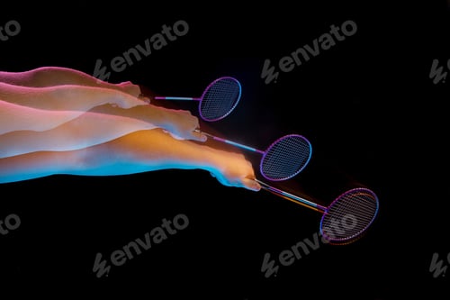 Preview: The Hands Of Young Man Playing Badminton Over Black Background