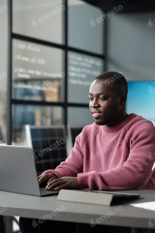 Preview: Young businessman networking by desk