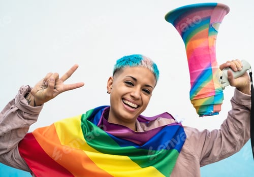 Preview: Young woman celebrating gay pride event wearing rainbow flag symbol of Lgbt social movement