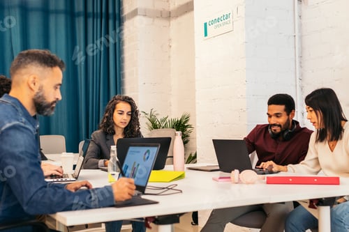 Preview: Group of multiracial people working with laptop in a coworking