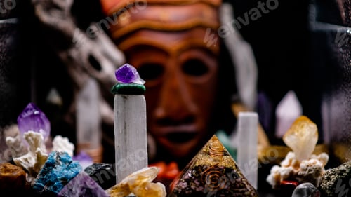 Preview: Composition of crystal stones and a mystique mask in the background- the concept of crystal healing