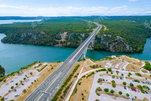 Preview: Transport bridge over the sea, cars are parked in the parking lot near the motorway.
