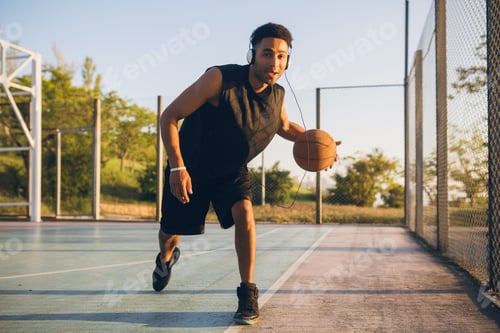 Preview: black man doing sports, playing basketball on sunrise, active lifestyle, sunny summer morning