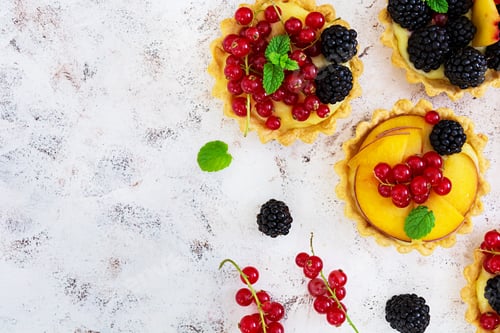Preview: Tartlets with different berries on white background. Top view
