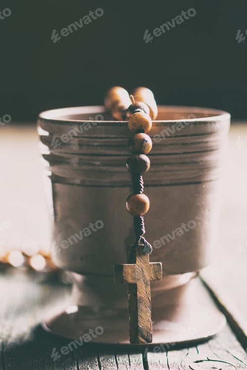 Preview: Rosary beads and cup of wine.
