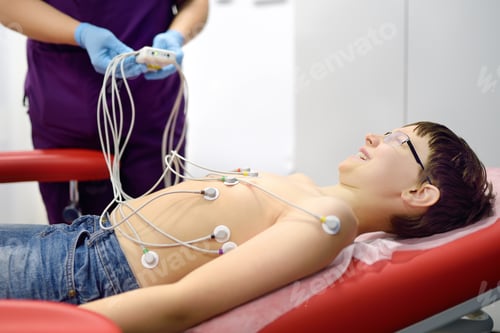 Preview: Child under ECG test with doctor. Boy patient lying in medical bed with vacuum sensors.