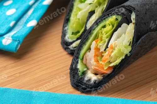 Preview: Tortilla wrap with shrimps and vegetables on wooden background