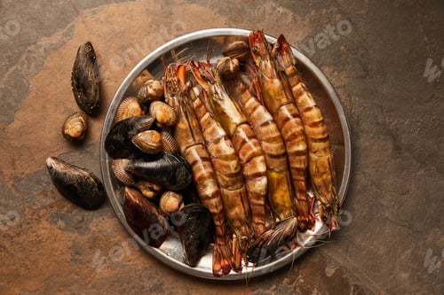 Preview: top view of shellfish with cockles and mussels in bowl on textured surface