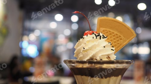 Preview: Ice cream sundae with whipp cream and cherry close up