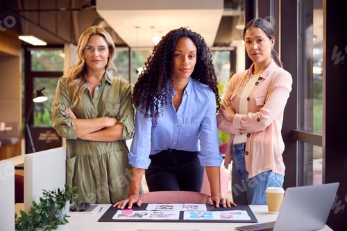 Preview: Portrait Of Female Business Team In Open Plan Office Approving Checking Proofs Or Design Layouts