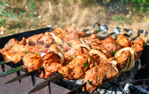 Preview: Grilled marinated meat with onion on skewers.