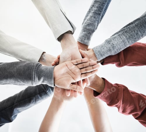 Preview: Low view of Group of businesspeople stacking their hands in support with their colleagues standing